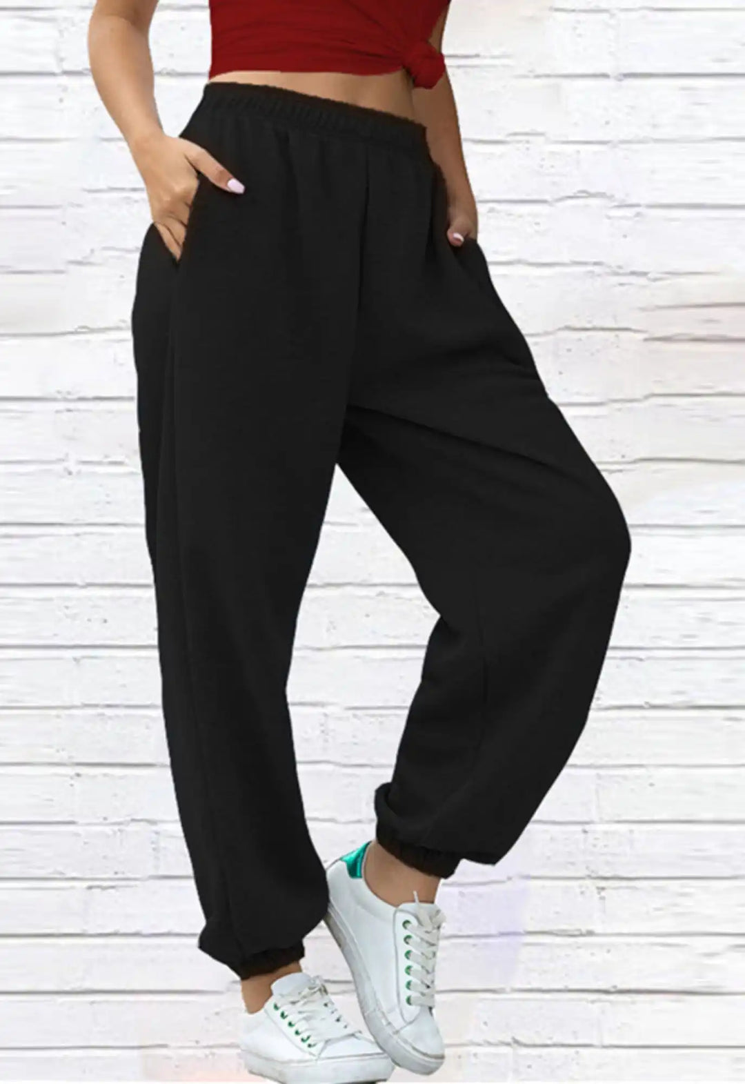 Black elastic-waist jogger pants with side pockets and cuffed ankles.